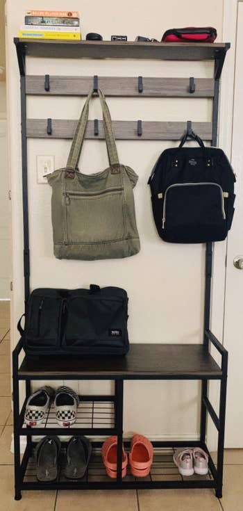 Reviewer image of the coat rack with backpacks and shoes