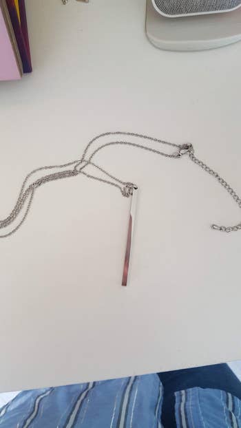 reviewer photo of a silver bar pendant necklace