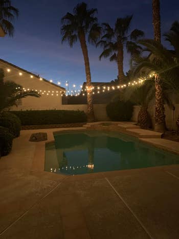 another reviewer's backyard with the lights fanning out over a pool
