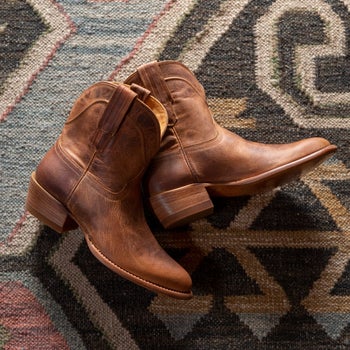 a close up on brown short cowgirl boots