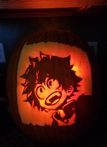 a carved pumpkin showing midoriya from my hero academia