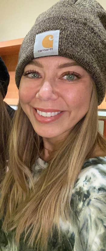 reviewer smiling wearing beanie in grey