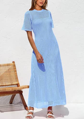 Person wearing a long, patterned formal  with a relaxed fit, lasting  beside a wicker chair