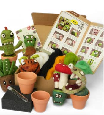 Cactus Creation Needle Felting Kit with various felted cactus characters, instructional booklet, and small pots, perfect for crafting enthusiasts