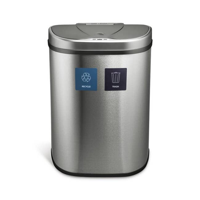 A silver recycling/ trash bin 