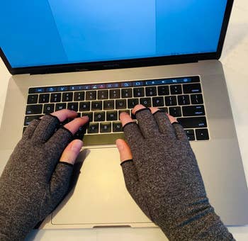 reviewer wearing the gray gloves while typing