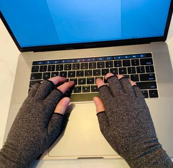 reviewer wearing the gray gloves while typing