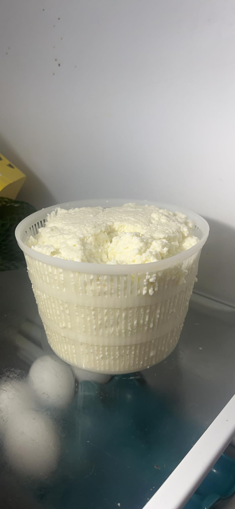 Container of caller  ricotta food  connected  a solid  support  successful  a refrigerator adjacent  to eggs and a box