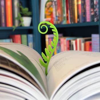 Book with a vibrant fern-shaped bookmark 