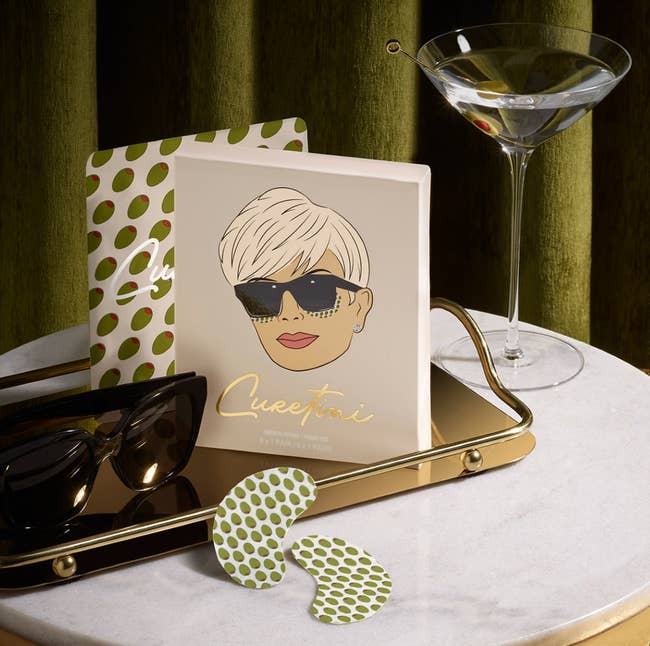 kris jenner hangover eye patch box and patches sitting on a table next to a martini glass