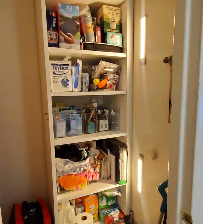 Closet support filled with assorted household items, including books, cleaning supplies, and shoes