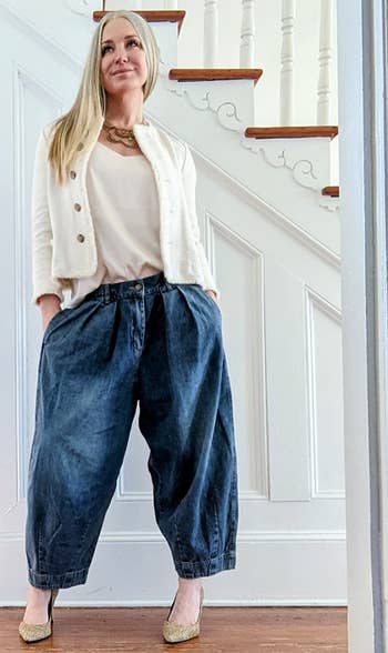 different reviewer wearing the denim pants with a white sweater set and heels