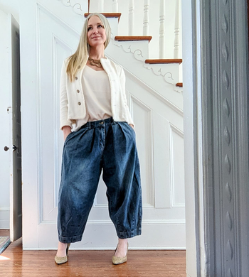 different reviewer wearing the denim pants with a white sweater set and heels