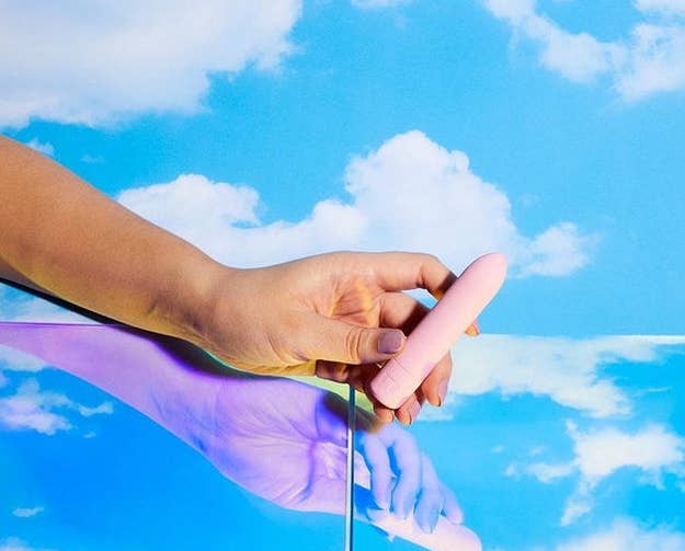 hand holding the pink zip vibe against a blue sky background