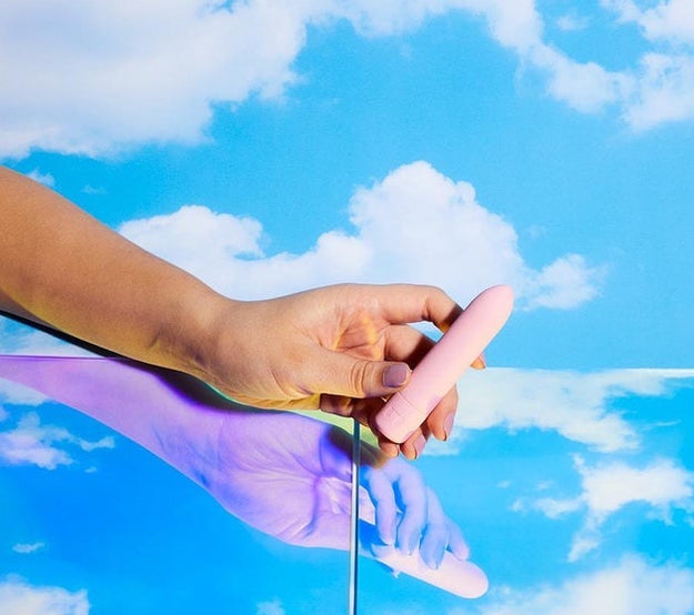 hand holding the pink zip vibe against a blue sky background