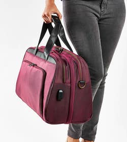 model holding the plum colored bag