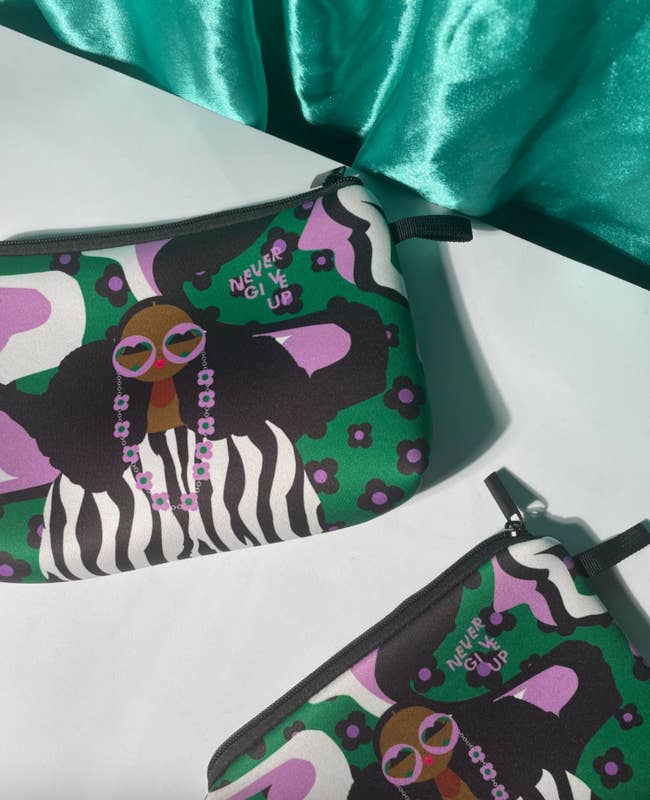 pouch with illustration of girl wearing sunglasses with green background and black and purple flowers