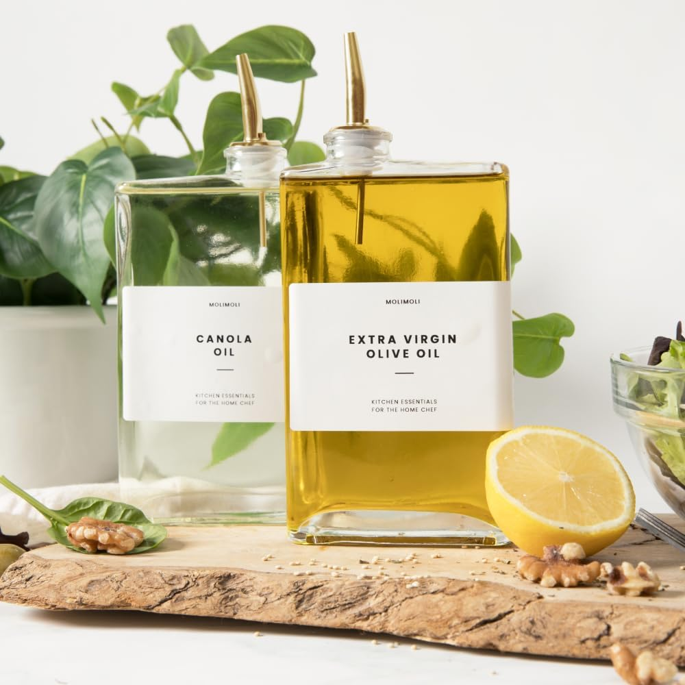 two slim, quadrate  bottles of oil, with golden  spouts and labels that work   Canola Oil and Extra Virgin Olive Oil