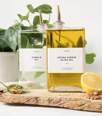 two slim, quadrate bottles of oil, with golden spouts and labels that work Canola Oil and Extra Virgin Olive Oil