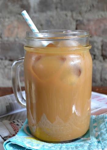 a glass jar with an iced coffee made at home with the concentrate