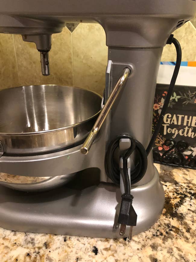 A stainless alloy room basal mixer connected a countertop with a cookbook titled