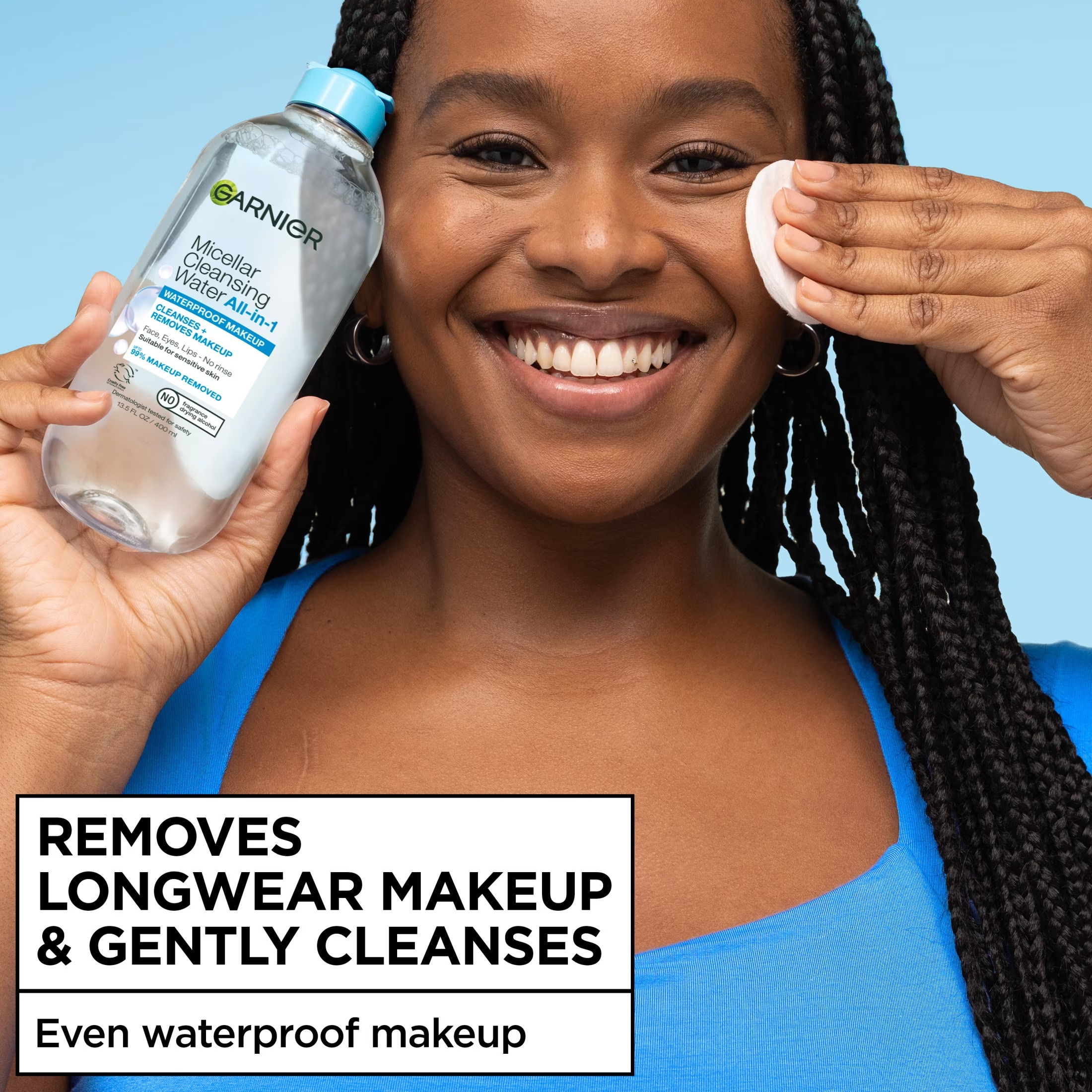 Person smiling, utilizing a fabric  pad with Garnier micellar cleansing h2o  connected  their face. Text highlights product's quality  to region   longwear makeup