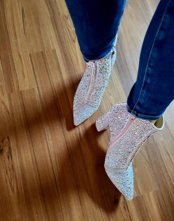 reviewer wearing the rhinestone boots with blue jeans