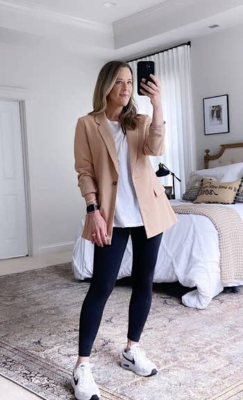 reviewer wearing the blazer in tan