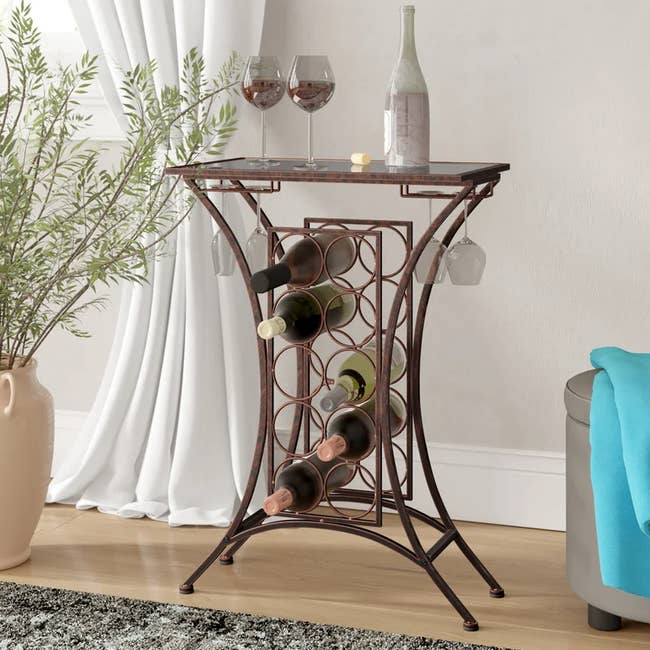 Image of the floor wine rack with bottles and glasses 