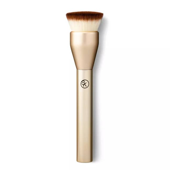 A makeup brush with a gold handle and angled bristles, ideal for applying foundation or blush, featured in a shopping article