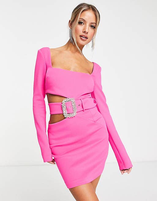 model in square neck long sleeve pink mini dress with side cutout and matching belt with jeweled buckle