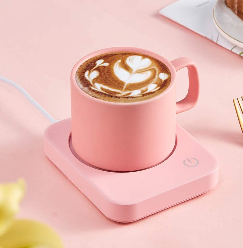 a pink mug on a matching mug warmer