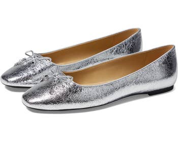 Silver metallic ballet flats with bow detailing, suitable for casual and ceremonial wear