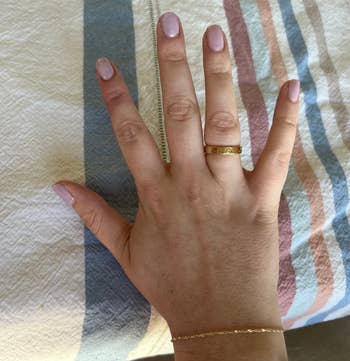 buzzfeed editor wearing a gold cartier love band ring