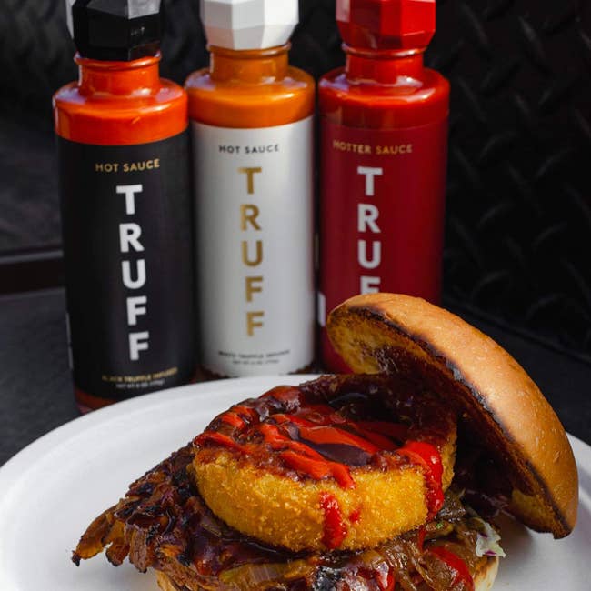 burger with truffle hot sauce on it