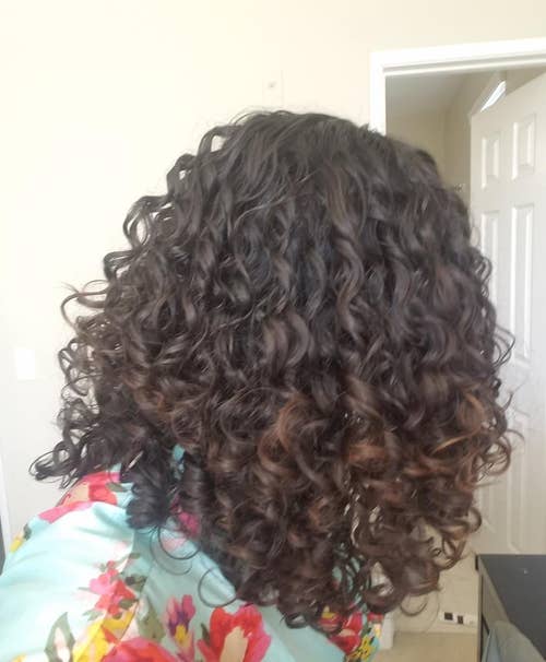 Reviewer with bouncy curls after using the travel diffuser