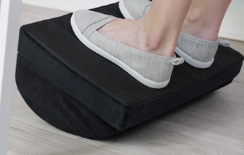 same model's feet with the footrest turned over using it as a rocker