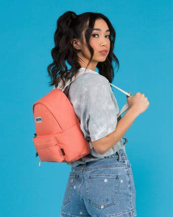 model wearing the red backpack