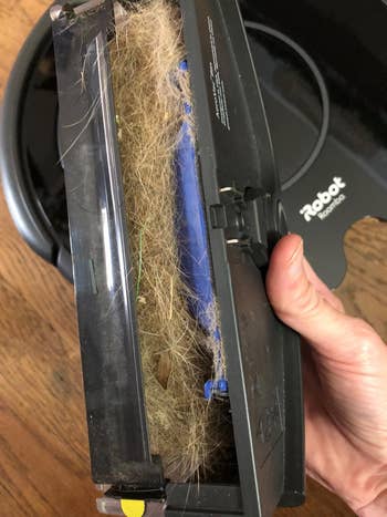 reviewers Roomba opened showing all the dirt and pet hair it collected
