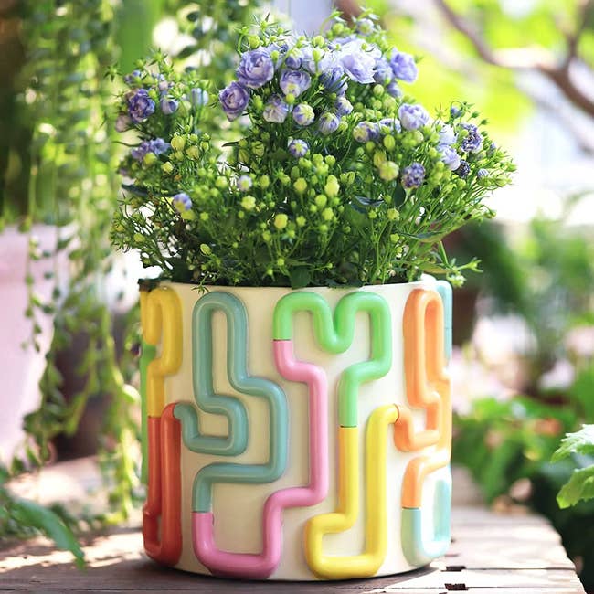 ceramic vase with multi color squiggle pattern in 3d around it