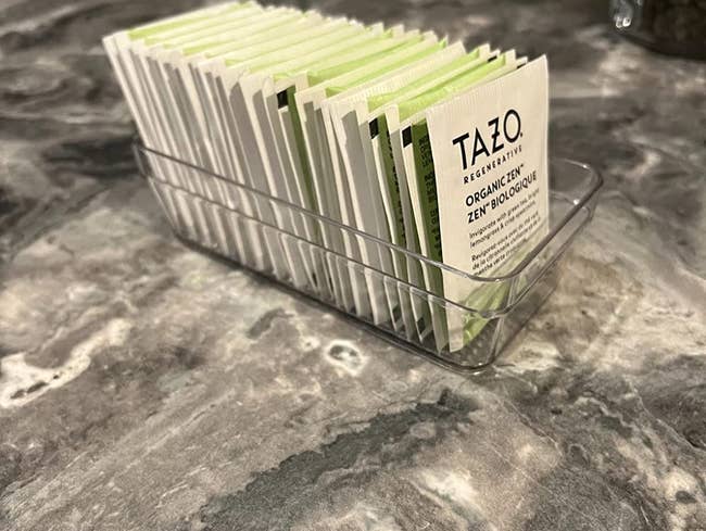 reviewer photo of tazo tea sachets in a clear acrylic organizer bin
