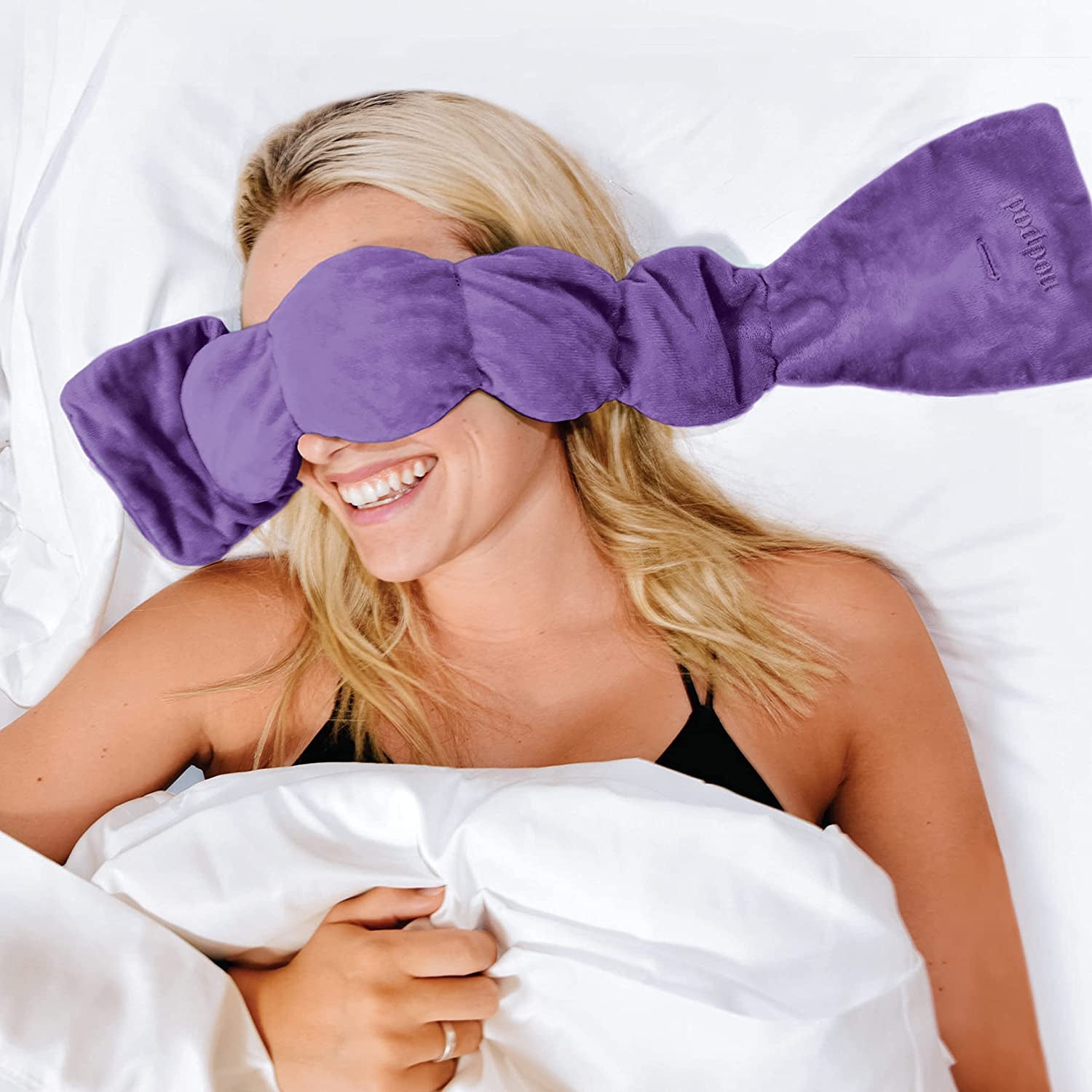a model wearing the purple sleep mask