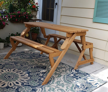 a reviewer photo of the same piece of furniture folded out into a picnic table
