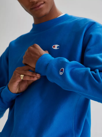 detail shot of the same reviewer wearing the crewneck in blue
