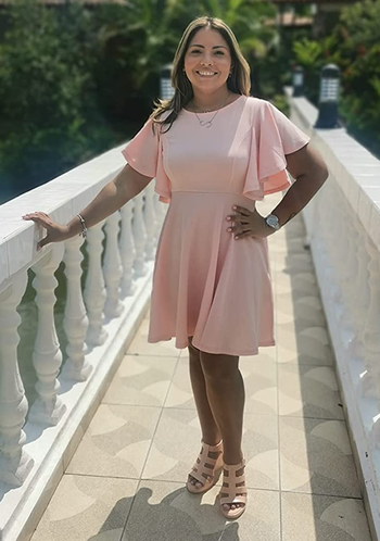 reviewer wearing the light pink dress with sandals