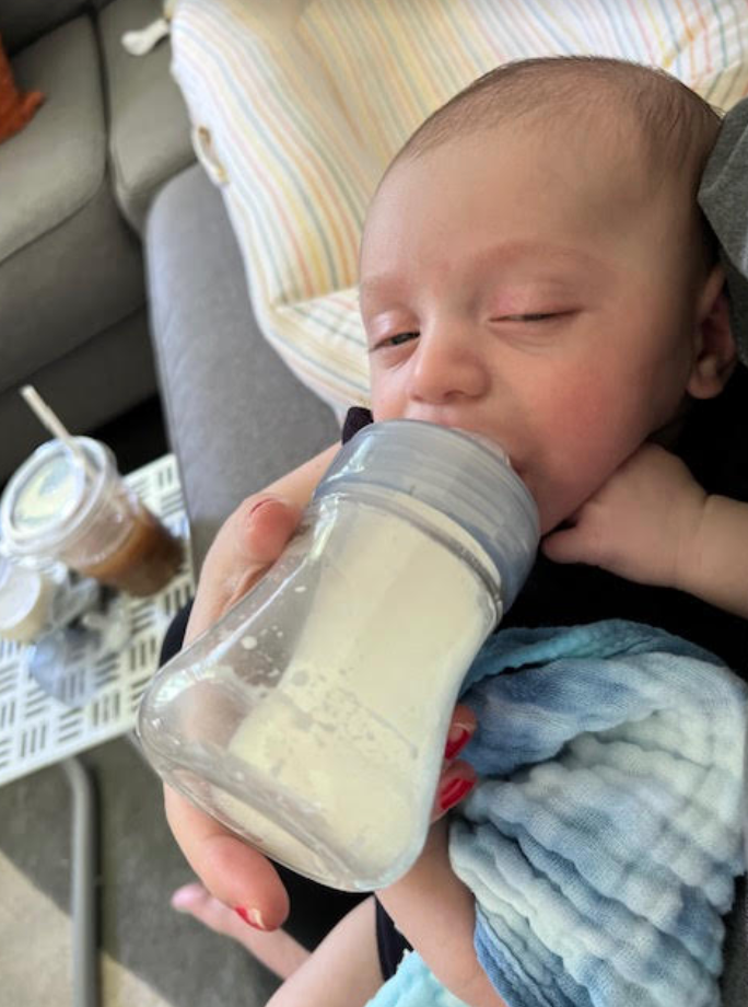 Pic of Heather holding Noah while feeding him with the Chico Duo bottle