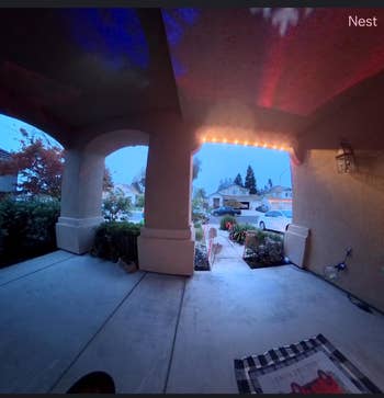 View from a structure showing a residential thoroughfare and parked cars successful a suburban vicinity astatine dusk