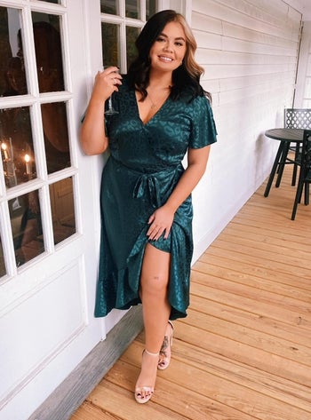 reviewer wearing the dress in teal