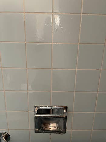 same reviewer's shower wall with clean grout lines and tile