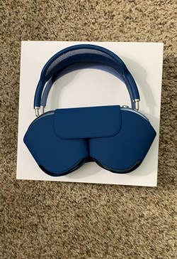 Reviewer's sky blue headphones with the case on them